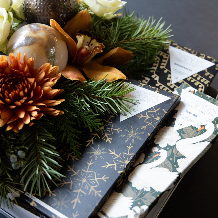 Decorative chocolate bars with floral arrangement and gold snowflake design