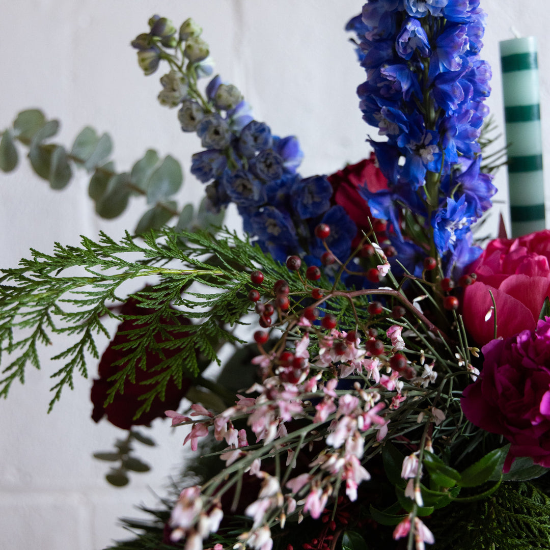 Bouquet of flowers with blue, pink, and green colors on a white background