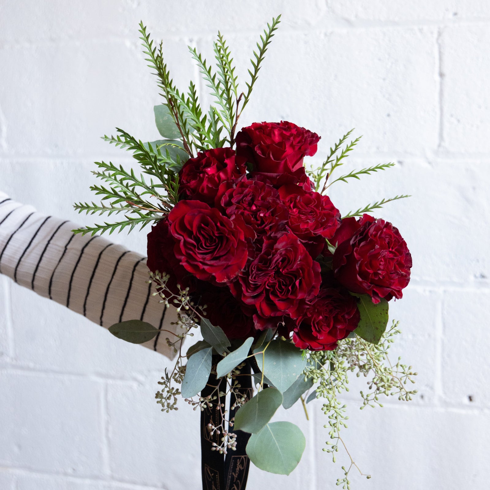 Dozen roses wrapped by Stacy K Floral