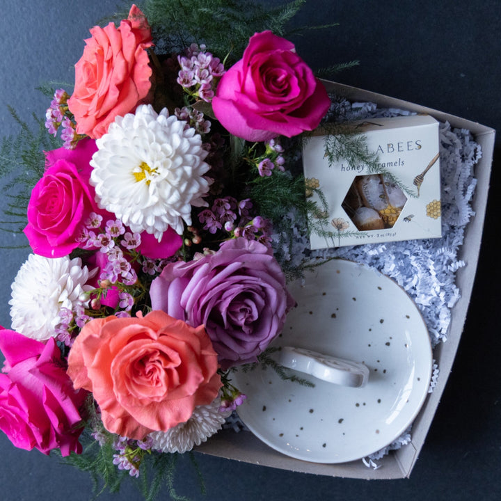 Bouquet of colorful flowers in a box on a dark background