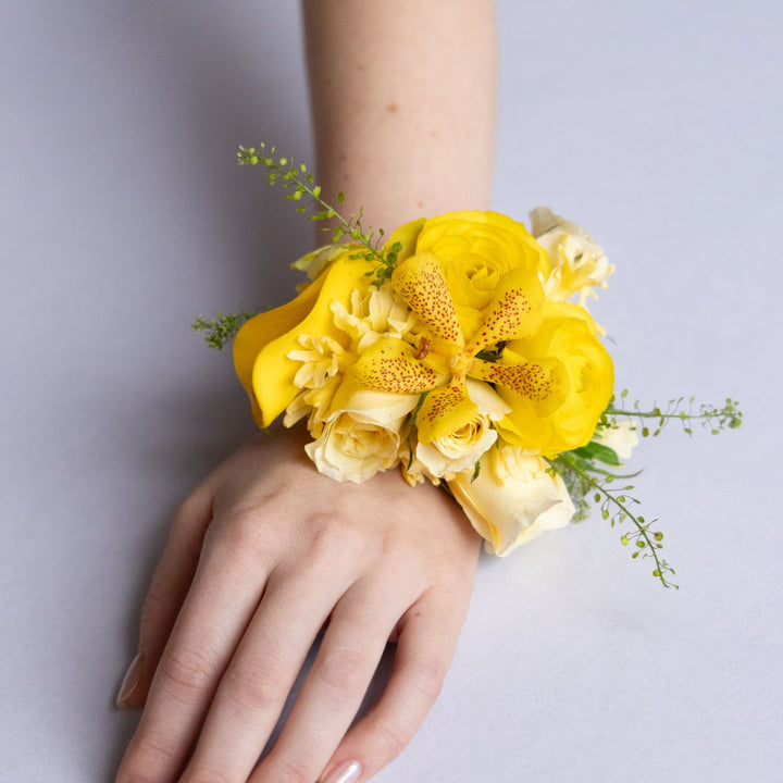 Yellow floral wrist corsage on a person&