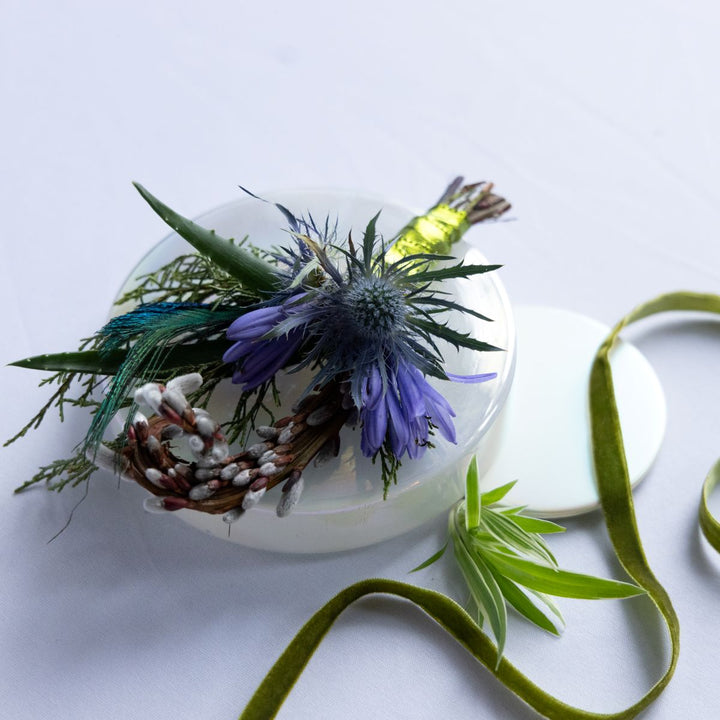 boutonniere with flowers and greenery on a white background