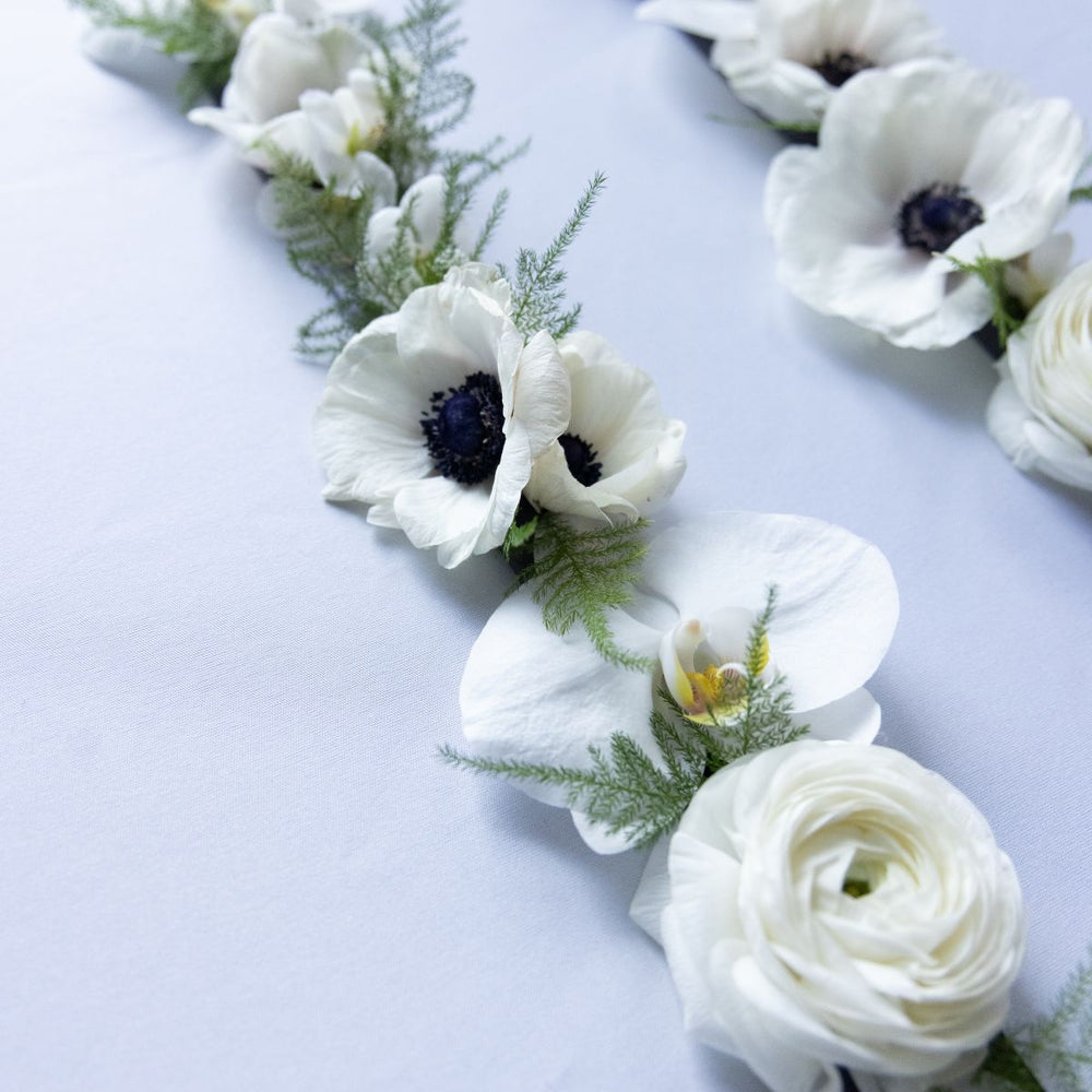 White flowers with greenery on a light background