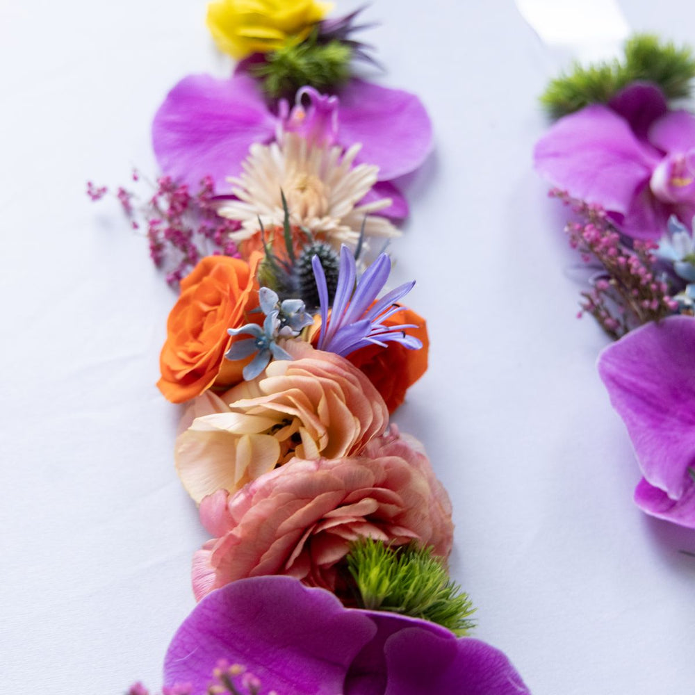 Colorful floral graduation stole on a white background