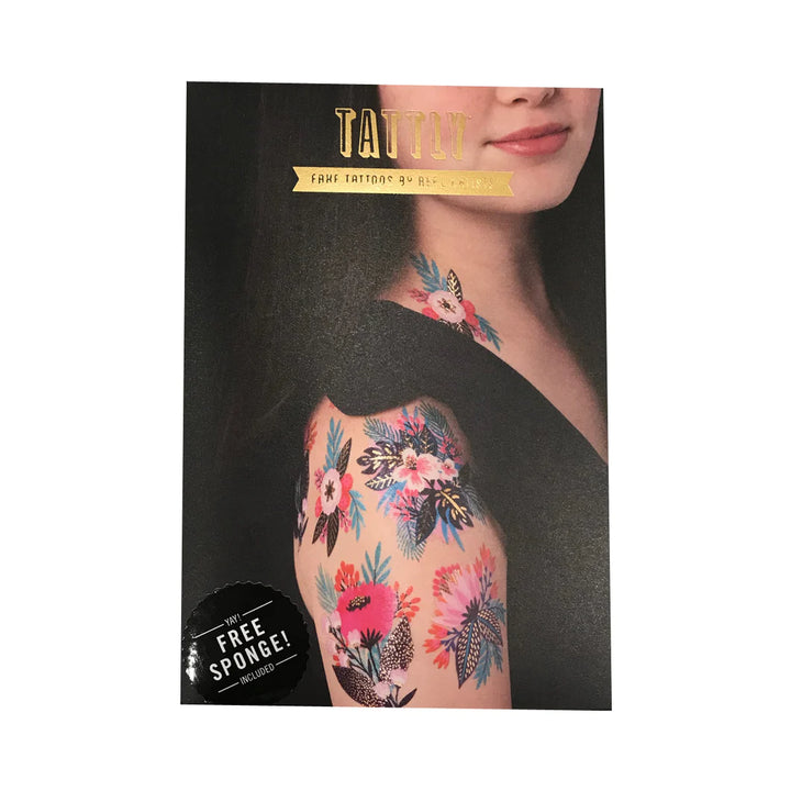 Tattly Tattoos | Photo of the packaging showing the tattoos on the model's shoulder. text reads "Tattly, fake tattoos by real artists, yay!, free sponge!, included.".