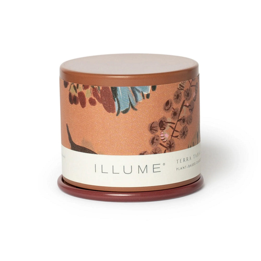 Demi Vanity Candle | Illume | A terra cotta colored tin candle with an orange floral patterned label.
