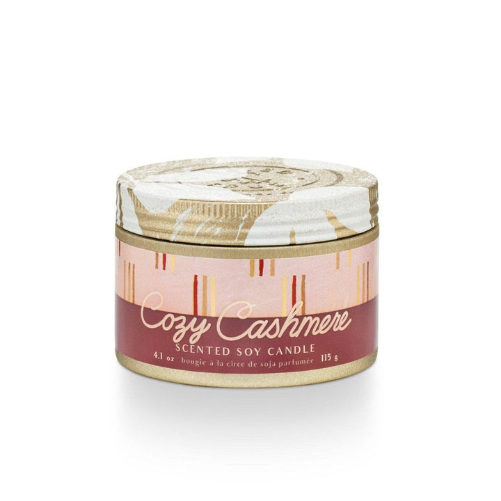 Tried & True Small Tin Candle | Cozy Cashmere | A gold tin candle with a red, pink, gold, and yellow label that reads "Cozy Cashmere, Scented Soy Candle, 4.1 oz, bougie a la circe de soja parfumee, 115g".