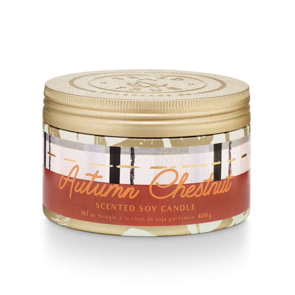 Tried & True Large Tin Candle | Autumn Chestnut | A red, orange, black and white label that reads "Autumn Chestnut, Scented Soy Candle, 14.1 oz, bougie a la circe de soja parfumee, 400g" on a gold patterned tin.