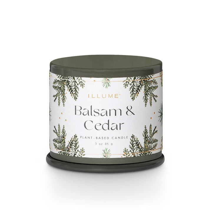 Illume Demi Tin Candle | Balsam & Cedar | A green tin with a white label decorated with cedar and balsam & Cedar, plant based candle, 3oz, 85 g."