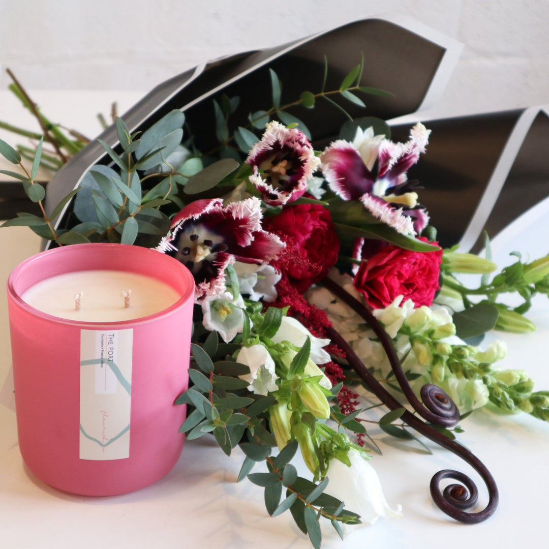 Fleurish and Flowers | This Set includes a scented " PORT" pinkFleurish Candle and a wrapped bouquet including purple tulips, dark pink roses, white snap dragons, white campanula.