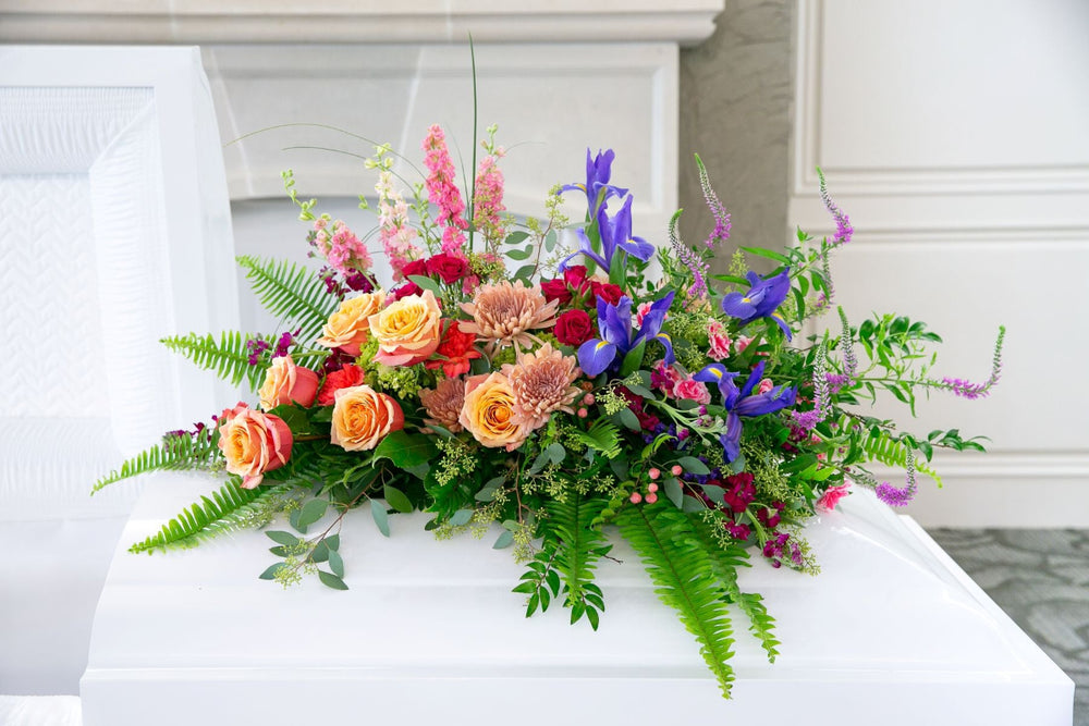 Colorful floral arrangement on a white surface with a neutral background