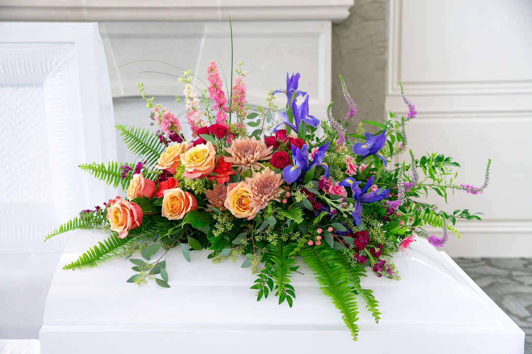 Colorful floral arrangement on a white surface with a neutral background