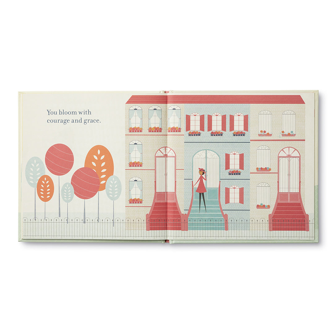 Celebrating You (and the beautiful person you are) | Open book spread with text " You bloom with courage and grace." Illustration depicts trees and brownstone houses with the main character on the steps.