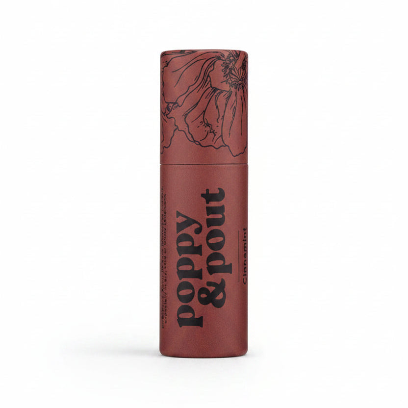 Poppy &amp; Pout Lip Balm | A red lip balm stick with trendy black line illustration and text that reads "Poppy &amp; Pout Cinnamint".
