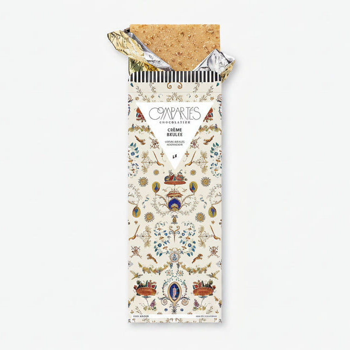 A chocolate bar with a decorative and colorful packaging, labeled &