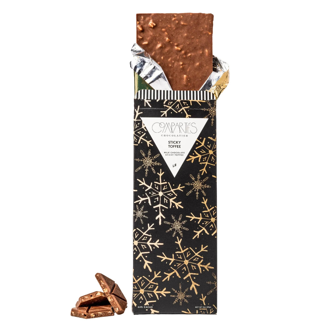 Compartes Sticky Toffee Chocolate, in a black box with gold snowflakes.
