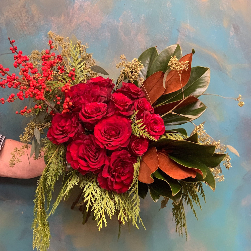 Dozen roses wrapped on blue background