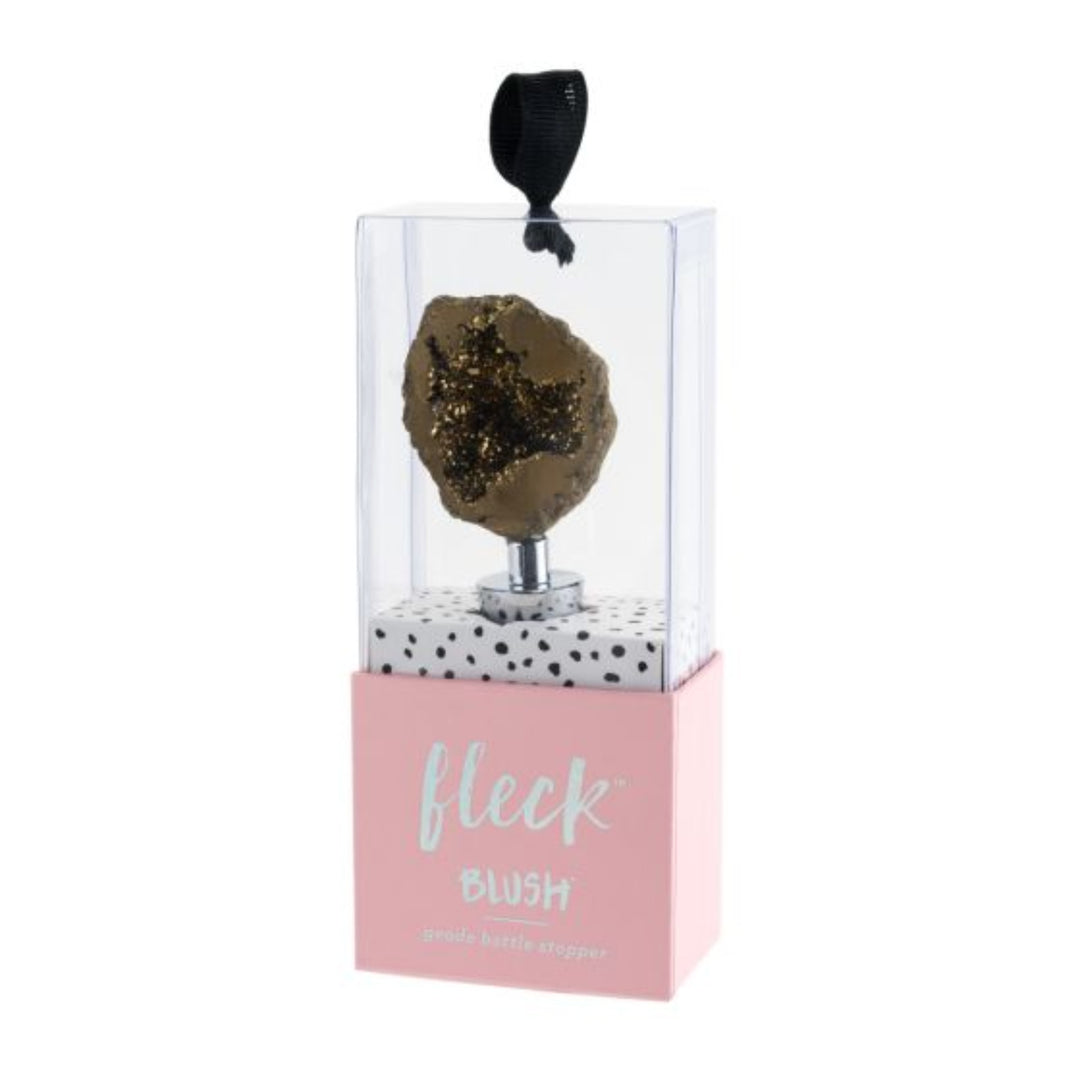 Fleck Blush Geode Bottle Stopper in gold. Packaging is transparent on top revealing the geode stopper, and has a pink base.