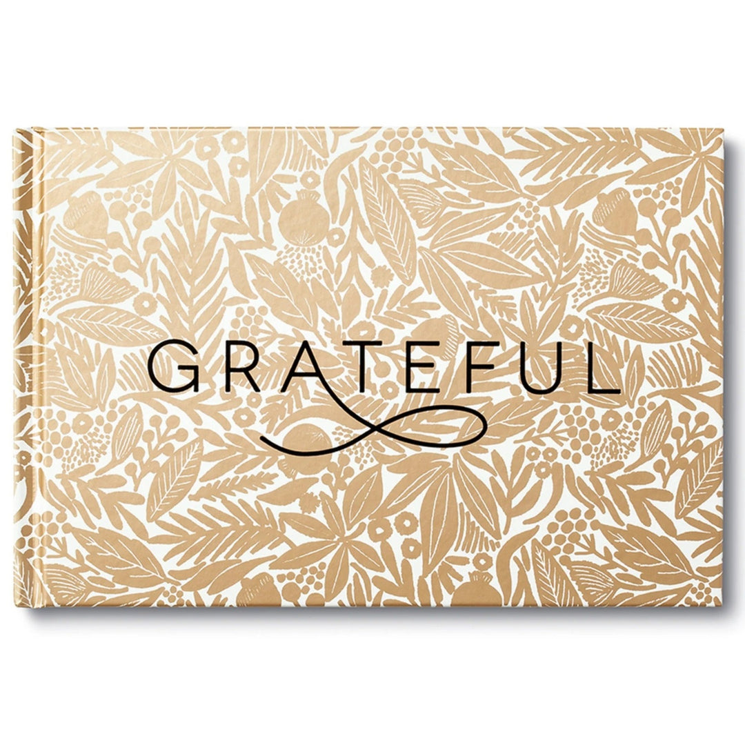 Grateful | A landscape oriented book with "Grateful" written in black over a gold/white leafy background.