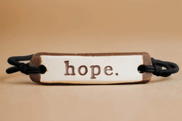 MudLOVE Original Bracelet | "Hope." ceramic piece with a black elastic cord.