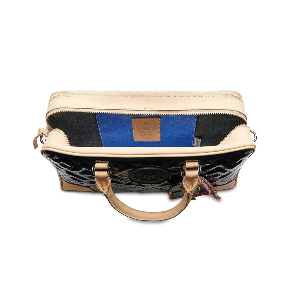 Inked Satchel | Consuela | Top view of the satchel showing the sparkly black interior and sparkly blue interior pocket.