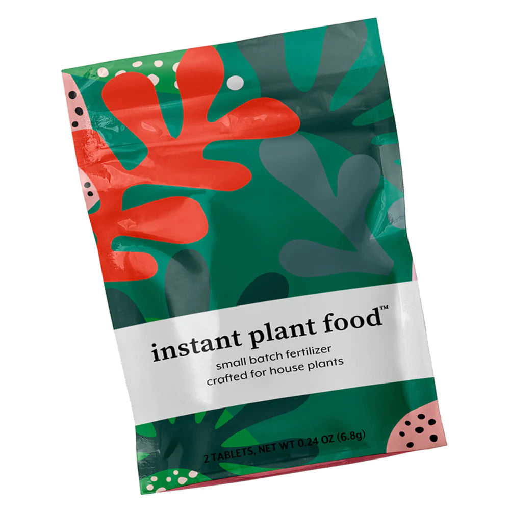 Instant Plant Food | Small batch fertilizer crafted for houseplants. 2 Tablets, net wt 0.24 oz (6.8g). Abstract botanical pattern in green, pink, and red.