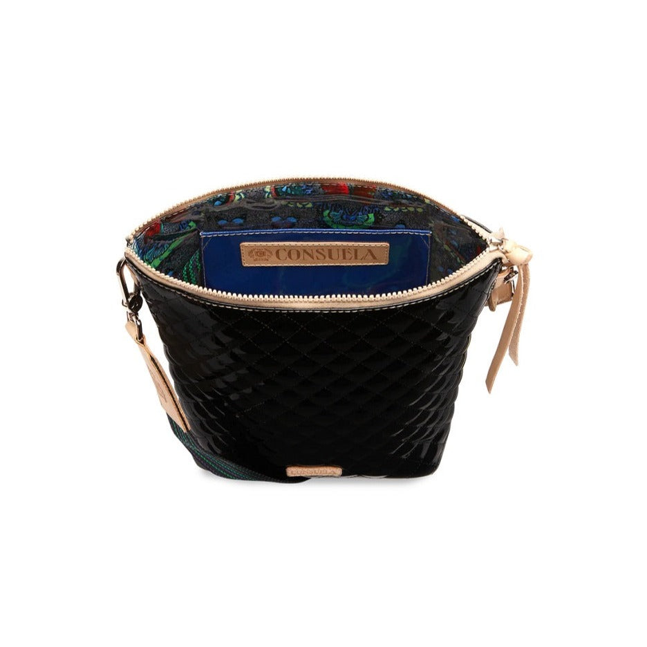 Jax Wedge | Consuela | A glossy black bag with the multi color silver/blue/green/red interior pattern showing as well as a sparkly blue interior pocket.