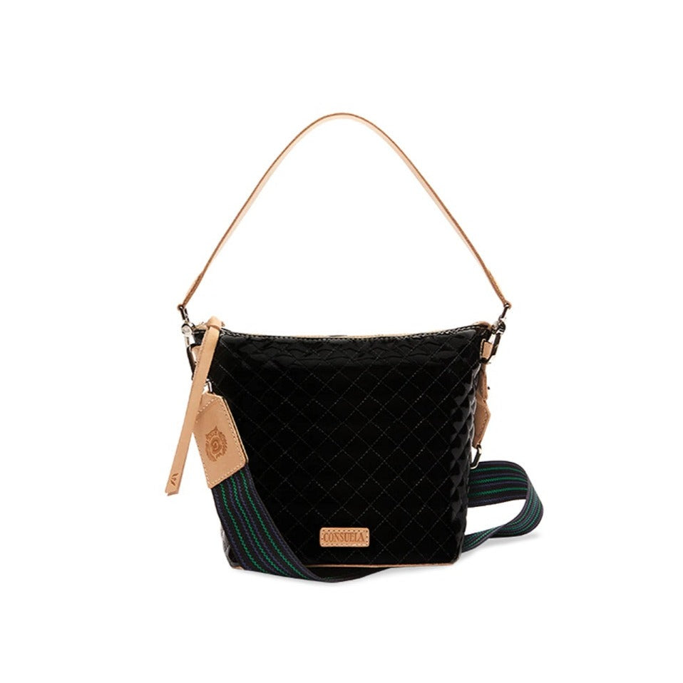 Jax Wedge | Consuela | A glossy black bag with Diego leather accents/handle and a green/blue crossbody strap.