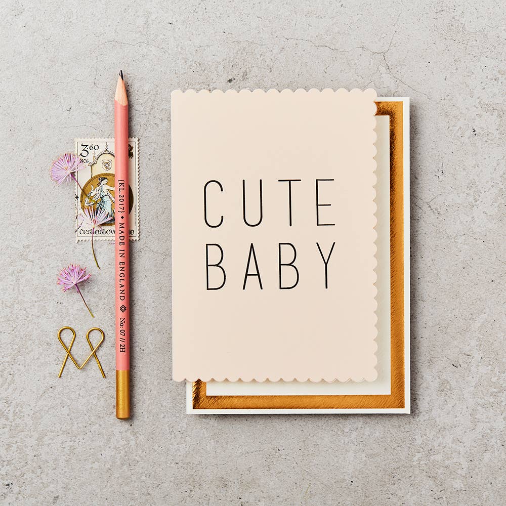 Cute Baby Card | A light colored card with black text "Cute Baby" and scalloped edges.