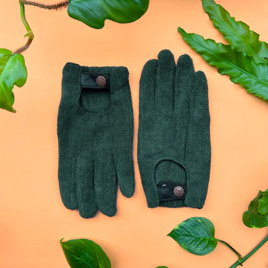 Leaf Cleaning Gloves | We The Wild | Green gloves with a adjustable button snap wrist and micro fibers. Background is orange with botanical accents.