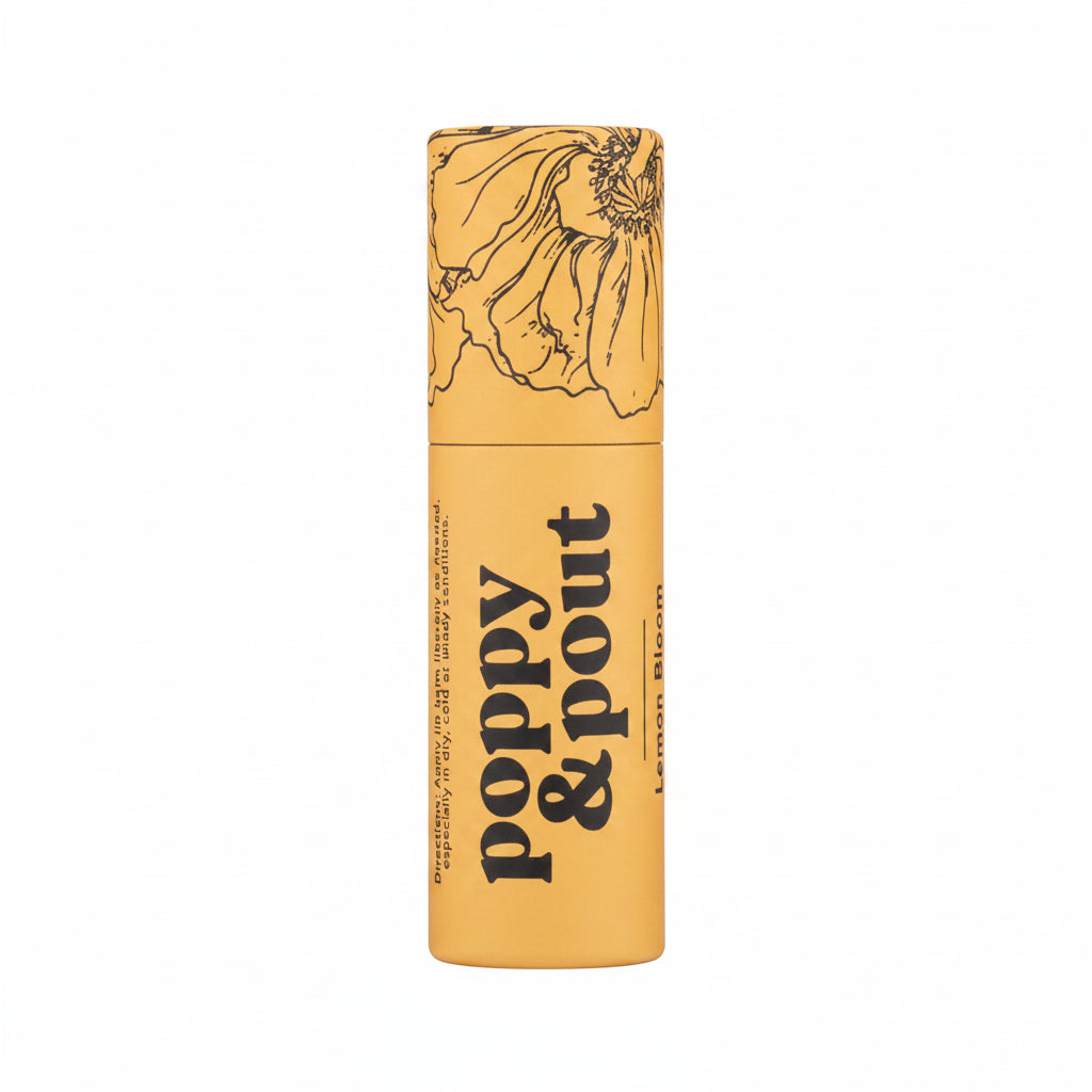Poppy and Pout Lip Balm | A yellow lip balm stick with trendy black line illustration and text that reads "Poppy &amp; Pout Lemon Bloom".