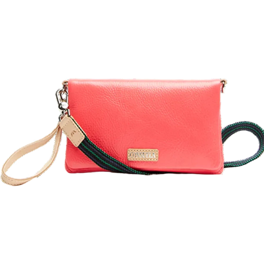 Maron Uptown Crossbody Bag | Consuela | A pink bag with a green and blue strap. Nude color accent leather.