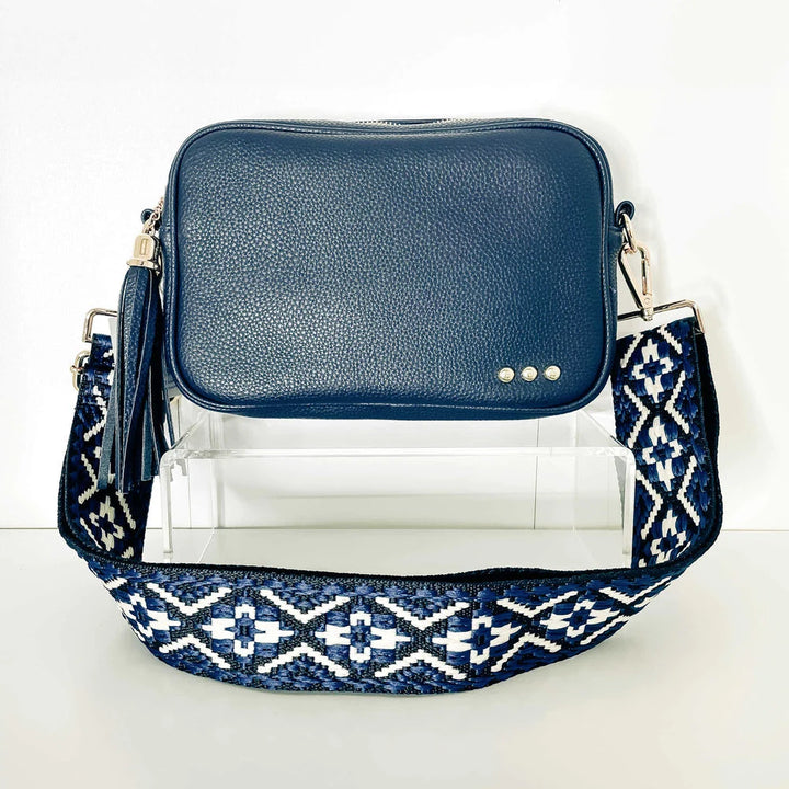 Willow Camera Crossbody Bag | Navy blue cross by bag in an elegant rectangle shape with a navy tassel and a blue, black, and white patterned strap.