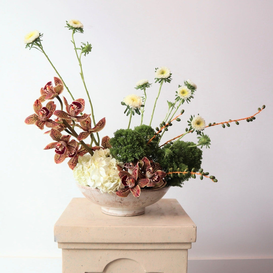 Magnificent | A natural colored arrangement with orchis, hydrangea, greens, and other florals. 
