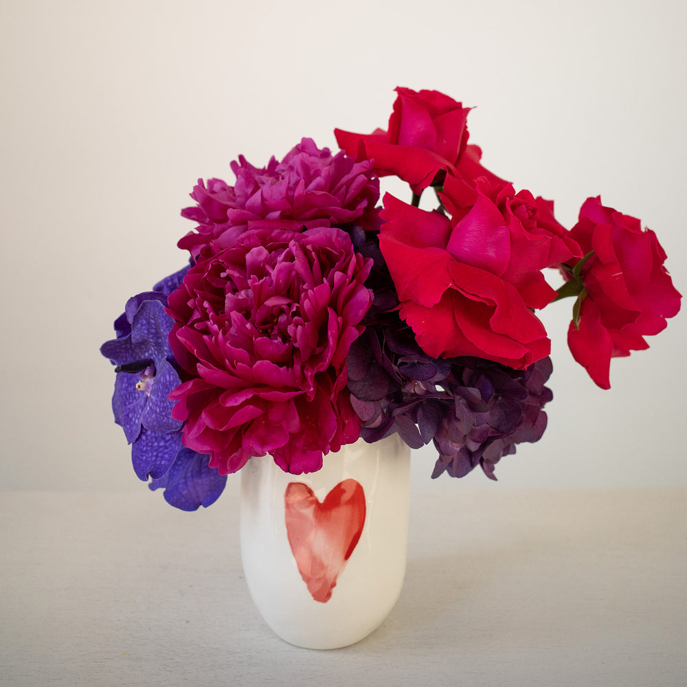 Water color heart vase with jewel tone blooms of heart roses, peonies and hydrangea. Valentines day flower delivery | Rochester NY florist 