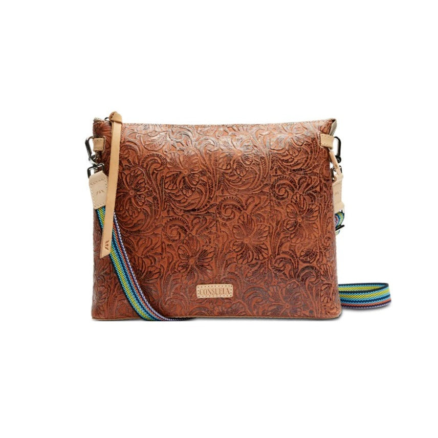 Sally Downtown Crossbody | Consuela | A brown leather bag with a floral/leaf pattern imprinted on. It has Diego leather accents and  multicolor crossbody strap.