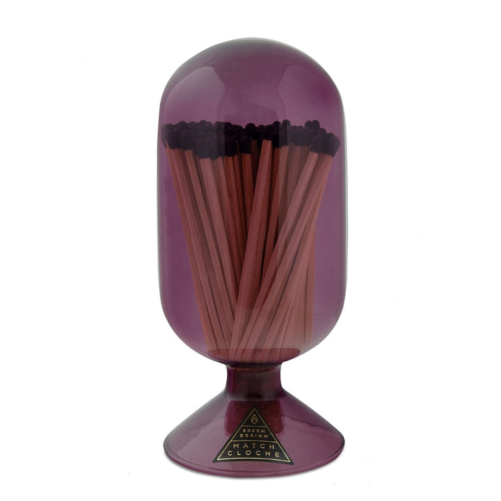 Skeem Mulberry Match Cloche | A Pink/Purple, Glass, Dome cloche. Tinted transparent glass with long stick matches. Photo taken on a white background.