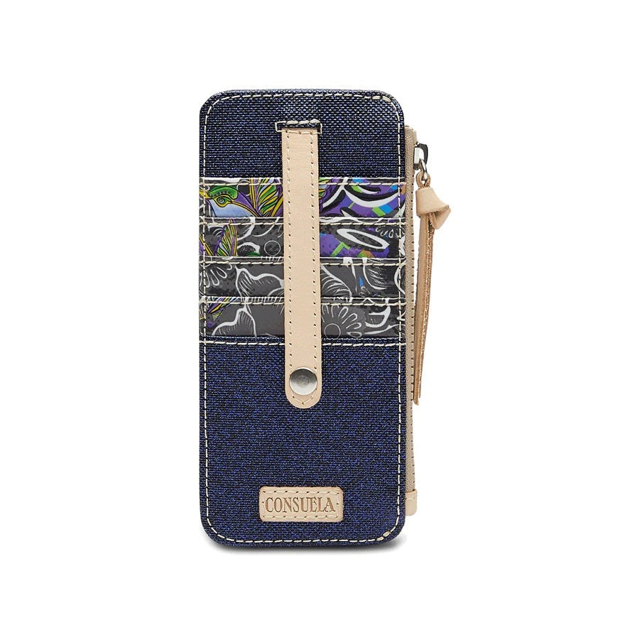 Card Organizers | Consuela | A blue/black card organizer with dark floral patterned in black, green, yellow, and purple card slots. Nude accent straps. Small piece at the bottom reads "Consuela".