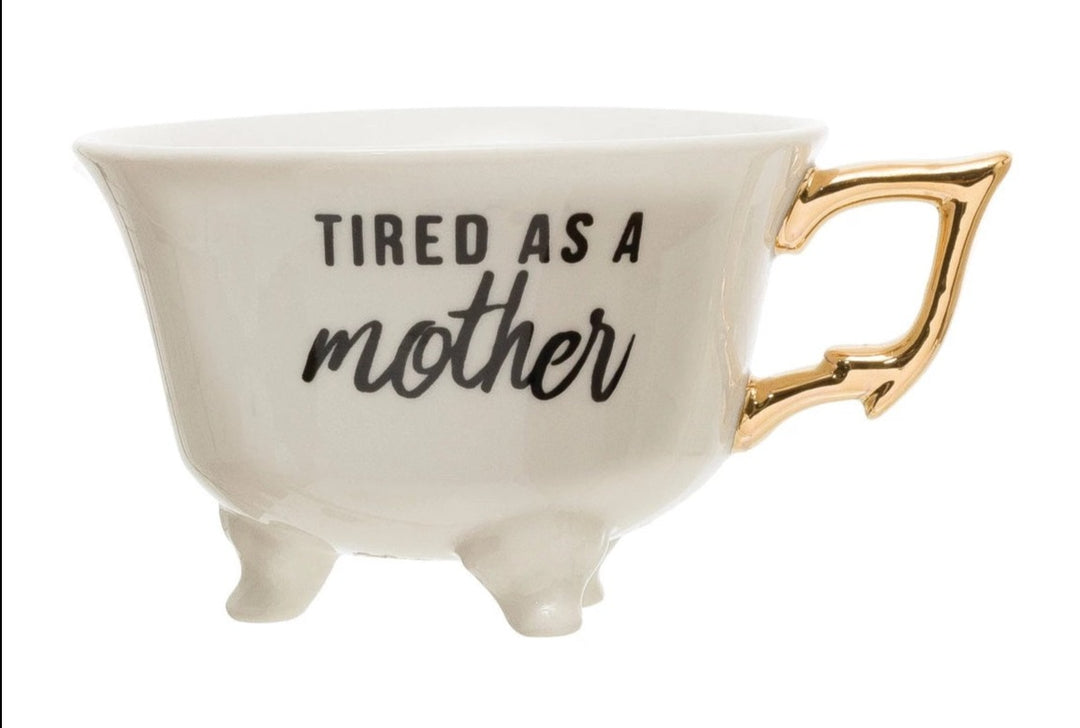 Saying Teacups | White Teacup with little feet and a gold handle. Reads "Tired As A Mother".