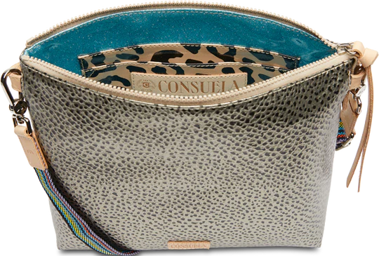 Tommy Downtown Crossbody | Consuela | Photo showing the interior of the bag, revealing the sparkly blue interior and leopard print patterned inner pocket.