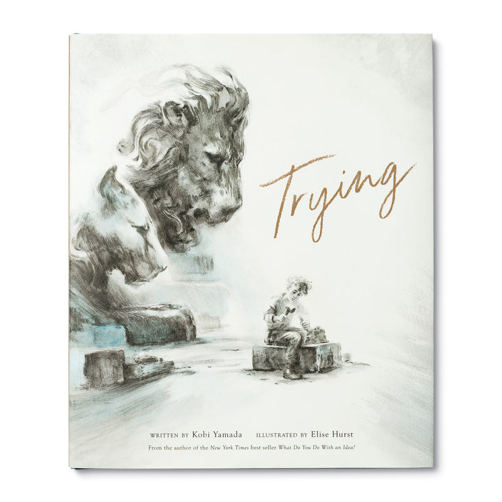 Trying | Written by Kobi Yamada and illustrate by Elise Hurst. From the author of the New York Times best seller "What Do You Do With an Idea". The cover is gray with hints of blue and depicts a boy practicing stone carving with a carved lion and lioness looking over him.