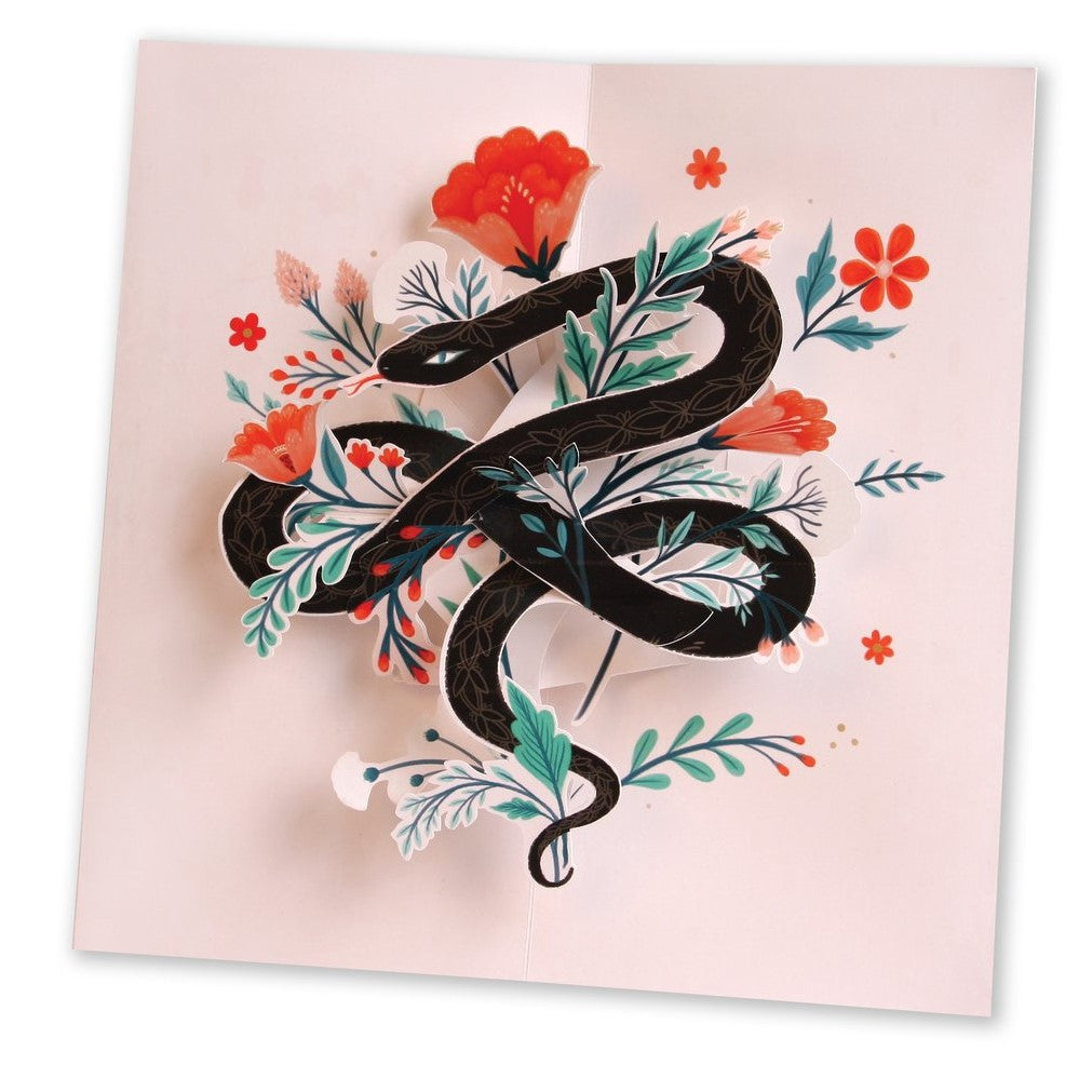 Charming - Pop Up Card | A light pink card with paper cutout snake and plants.