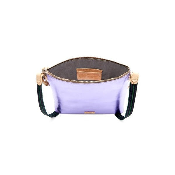 Val Downtown Crossbody | Consuela | Photo shows the simple purple backside of the bag and the sparkly gray interior.