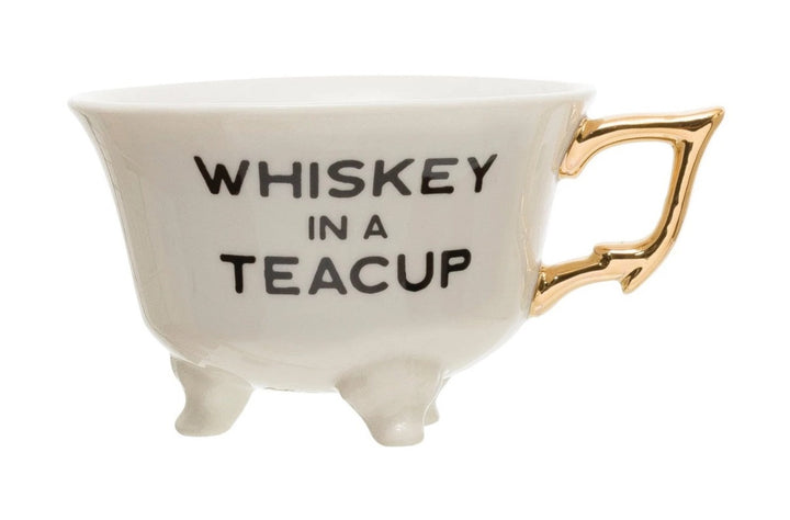 Saying Teacups | White Teacup with little feet and a gold handle. Reads "Whiskey In A Cup".