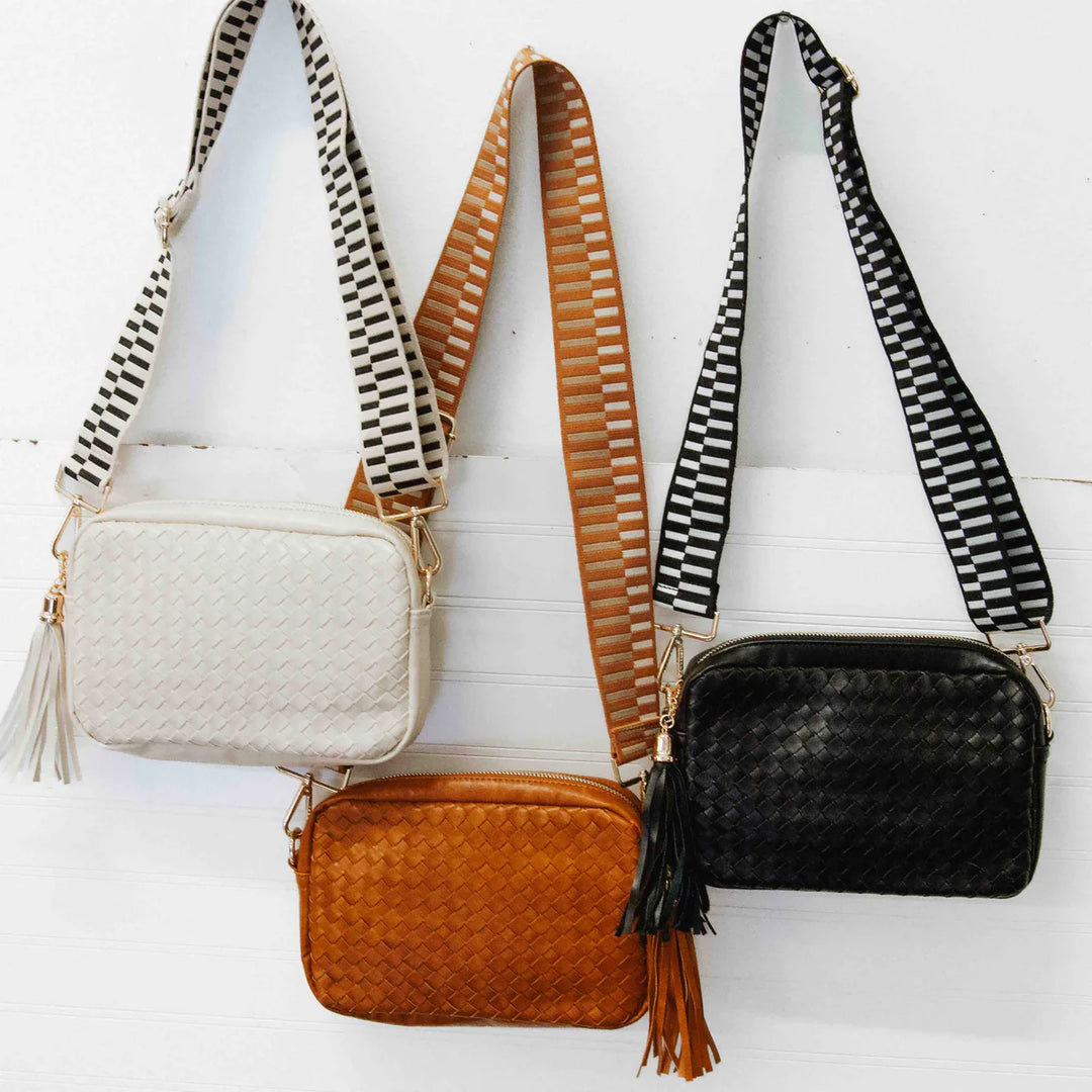 Woven Willow Camera Crossbody Bag | A bag with woven vegan leather pattern and a black/white strap. Colors pictured in cream, brown, and black. (Strap may vary from photo)