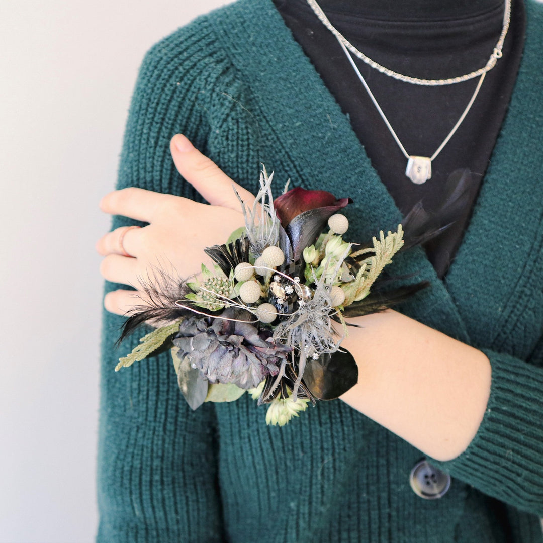 Midnight Corsage | A corsage with green, gray, black, and a touch of dark red. Accented with silver wire.