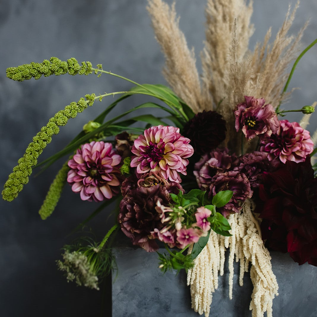 Stacy K Floral | A boho style arrangement with a mix of dried and fresh florals. Pampas grass, bleached ameranthus, dahlis, queen anne's lace, and more. Pink, green, and cream.