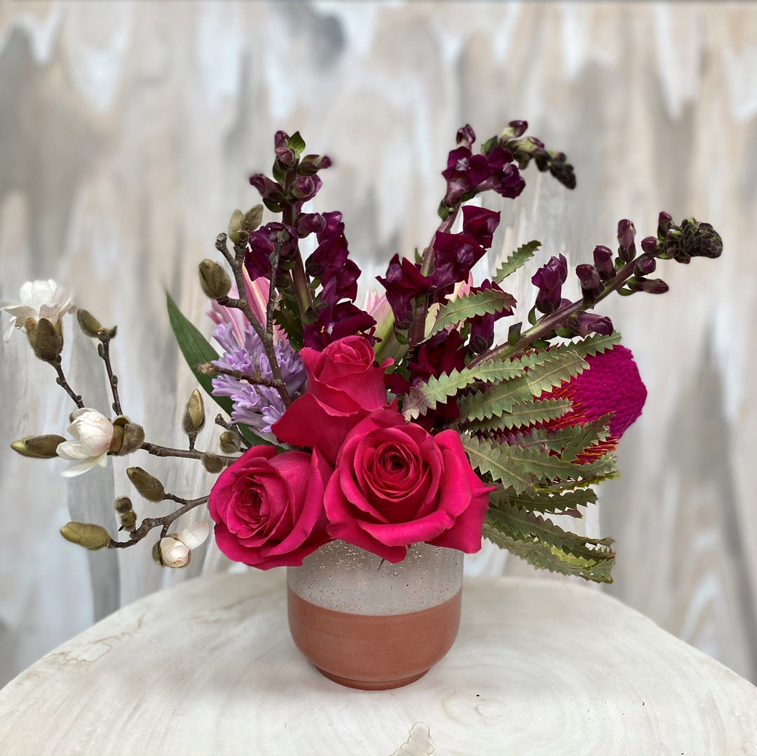 rose gold vase with pink and burgundy flowers