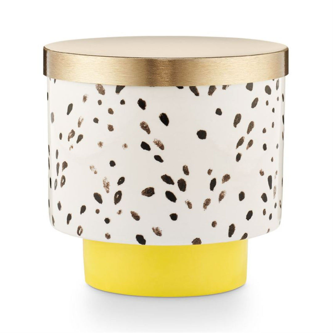 Go Be Lovely Lidded Ceramic Candle - Gold lid, Yellow base, and white with black speckled design on sides of candle.