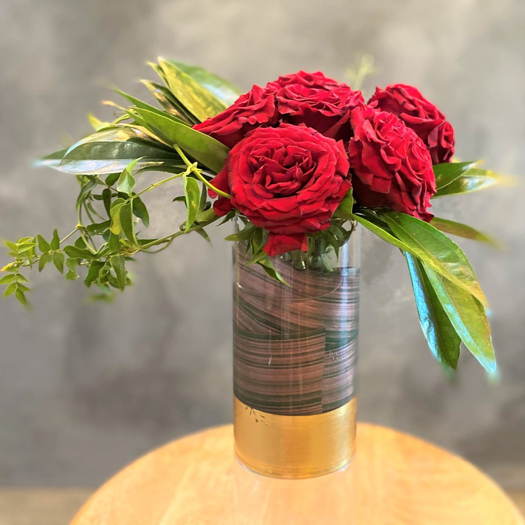 half dozen heart roses in a vase
